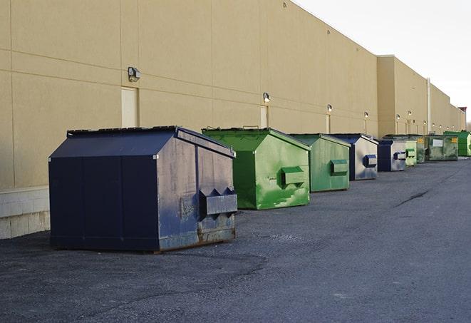 multiple construction dumpsters at a worksite holding various types of debris in East Palo Alto